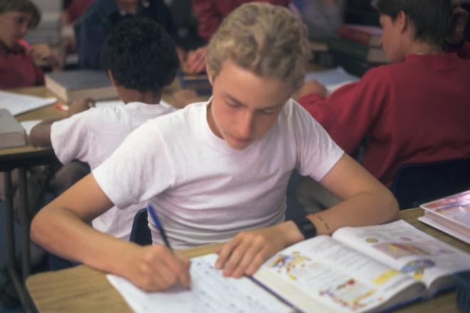 Castile Canyon Scientology School, student working out math in class room