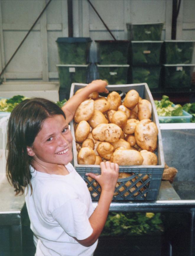 Castile Canyon Scientology School, girl with potato harvest