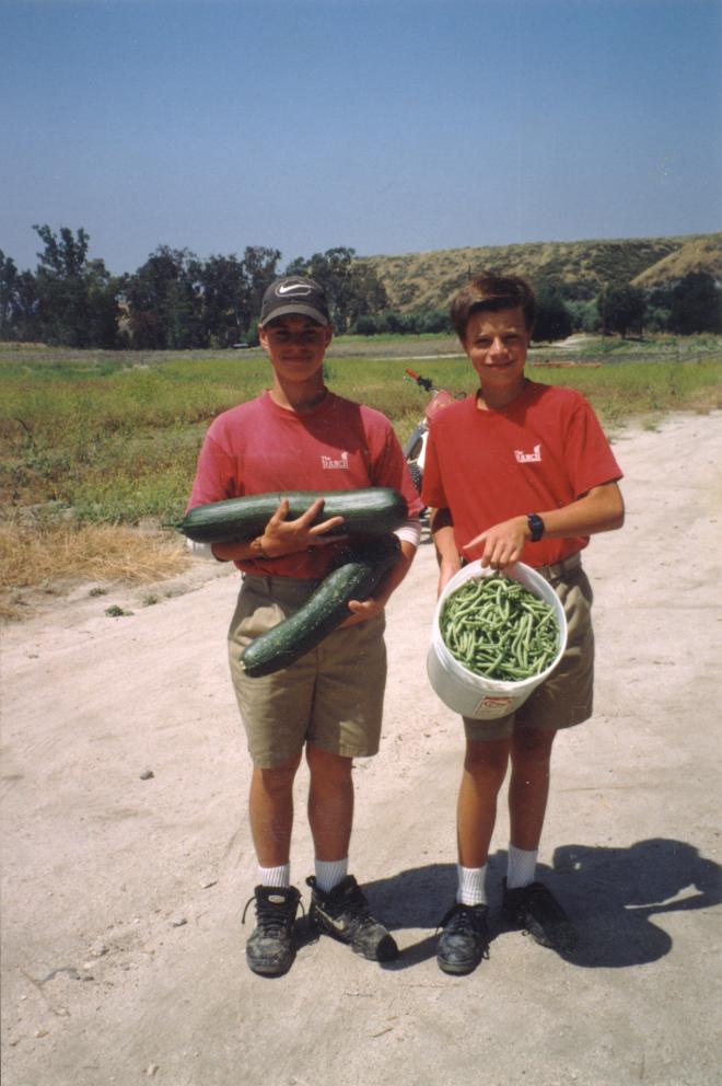 Castile Canyon Scientology School, boys showing beans and cucumber they learned to grow