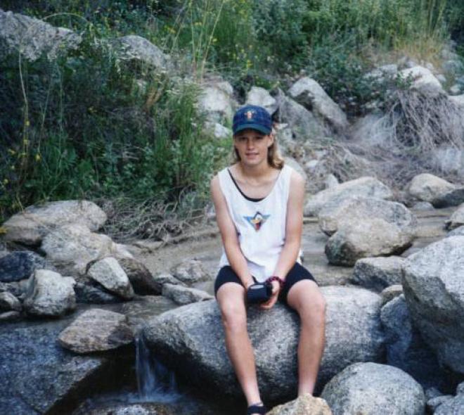 Girl at the Castile Canyon Scientology School, sitting at a creek